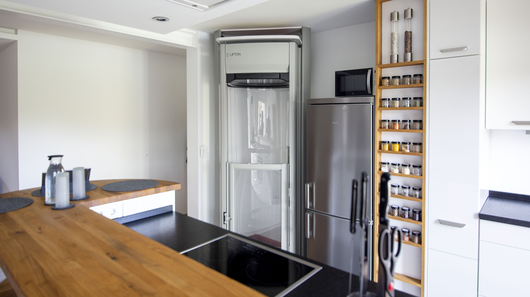Platzsparender Einbau eines Lifton Homelifts in der Ecke zwischen Kühlschrank und Türrahmen